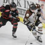 Kenai River Brown Bears forward Cody Moline works the puck past Corpus Christi (Texas) Ice Rays forward Anthony Yurkins on Friday, Feb. 8, 2019, at the Soldotna Regional Sports Complex. (Photo by Jeff Helminiak/Peninsula Clarion)