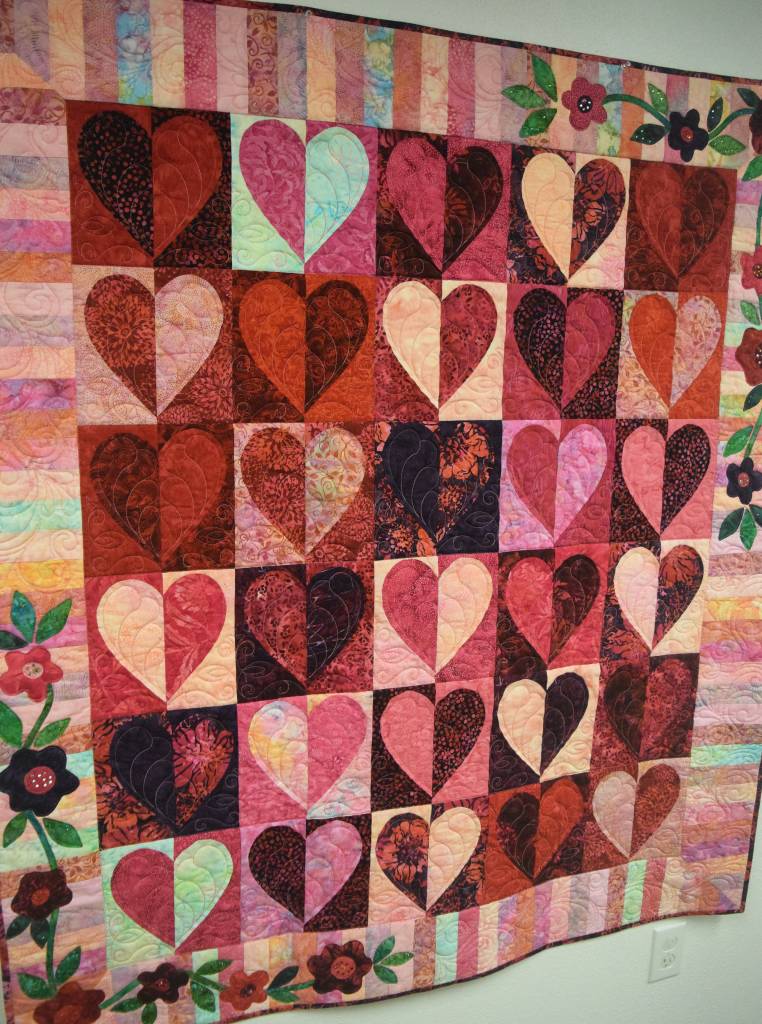 Heart to Heart, a quilt produced by local artist Pat Reese, hangs on the wall Thursday at the Kenai Fine Arts Center. (Photo by Joey Klecka/Peninsula Clarion)