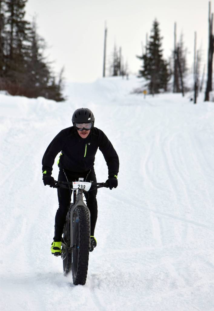 Mike Crawford barrels down a hill during Fat Freddies Bike Race and Ramble on Saturday, Feb. 9, 2019, in the Caribou Hills near Freddies Roadhouse. (Photo by Jeff Helminiak/Peninsula Clarion)