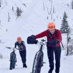 Tyle Owens pushes up a hill ahead of Chaz DiMarzio during Fat Freddies Bike Race and Ramble on Saturday, Feb. 9, 2019, in the Caribou Hills near Freddies Roadhouse. (Photo by Jeff Helminiak/Peninsula Clarion)
