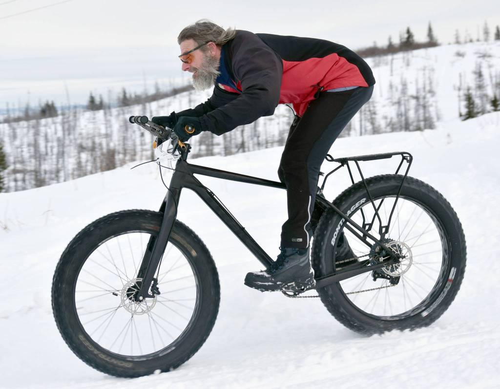 Brian Marang sails down a hill during Fat Freddies Bike Race and Ramble on Saturday, Feb. 9, 2019, in the Caribou Hills near Freddies Roadhouse. (Photo by Jeff Helminiak/Peninsula Clarion)