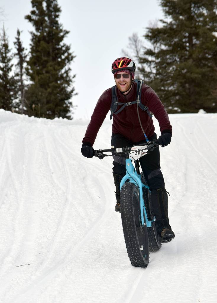 Ryan Peterson sails down a hill during Fat Freddies Bike Race and Ramble on Saturday, Feb. 9, 2019, in the Caribou Hills near Freddies Roadhouse. (Photo by Jeff Helminiak/Peninsula Clarion)