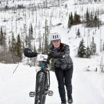 Simone Owens pushes her bike up a hill during Fat Freddies Bike Race and Ramble on Saturday, Feb. 9, 2019, in the Caribou Hills near Freddies Roadhouse. (Photo by Jeff Helminiak/Peninsula Clarion)