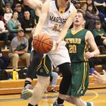 Homers Daniel Reutov sends the ball to a teammate under pressure from Seward players Friday, Feb. 8, 2019 during the Winter Carnival Basketball Tournament in Homer, Alaska. (Photo by Megan Pacer/Homer News)