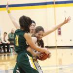 Homers Laura Inama tries to keep the ball away from Sewards Anevay Ammbrosiani (No. 11) and Katelyn Lemme (background) Friday, Feb. 8, 2019 during the Winter Carnival Basketball Tournament in Homer, Alaska. (Photo by Megan Pacer/Homer News)