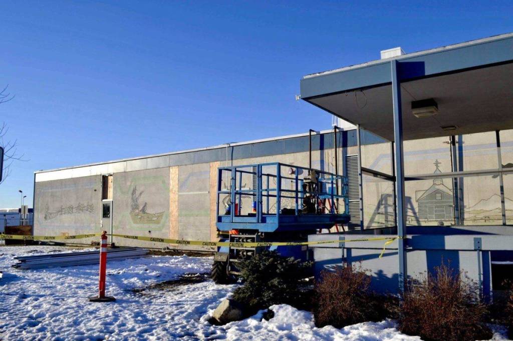 After construction workers removed siding from the facade of the Kenai Municipal Airport, a mural with iconic Kenai images like fishing nets, the St. Nicholas Russian Orthodox chapel and a dog musher, was revealed on Tuesday, Jan. 15, 2019 in Kenai, Alaska.(Photo by Victoria Petersen/Peninsula Clarion)
