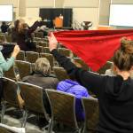 Protesters hold up flags during a public hearing on a draft environmental plan on proposed petroleum leasing within Alaskas Arctic National Wildlife Refuge on Monday, in Anchorage. Congress in December 2017 approved a tax bill that requires oil and gas lease sales in the refuge to raise revenue for a tax cut backed by President Donald Trump. (AP Photo/Dan Joling)