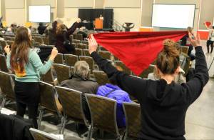 Protesters hold up flags during a public hearing on a draft environmental plan on proposed petroleum leasing within Alaskas Arctic National Wildlife Refuge on Monday, in Anchorage. Congress in December 2017 approved a tax bill that requires oil and gas lease sales in the refuge to raise revenue for a tax cut backed by President Donald Trump. (AP Photo/Dan Joling)