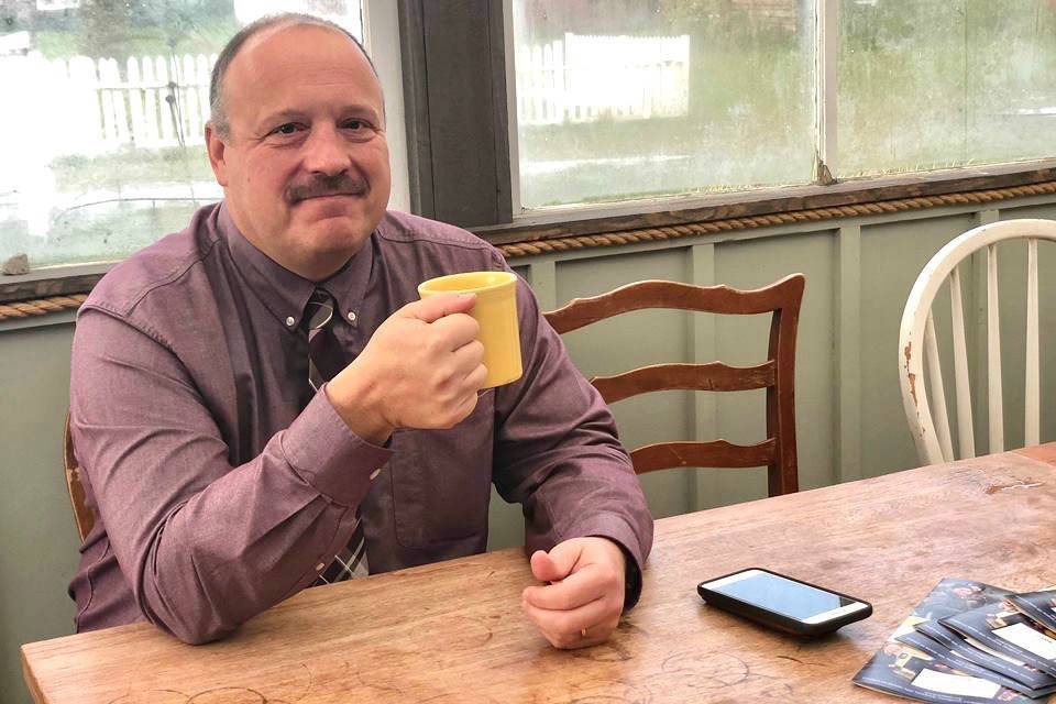 Kenai Peninsula Borough School District Superintendent Sean Dusek waits to talk and answer the publics questions in the back room of Veronicas Cafe in Kenai on Friday. (Photo by Victoria Petersen/Peninsula Clarion)