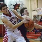 Homers Stanley Swoboda (right) tries to swipe the ball from Kenais Adam Trujillo Thursday in a conference clash at Kenai Central High School. (Photo by Joey Klecka/Peninsula Clarion)