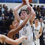 Soldotnas Tyler Morrison (4) puts up a shot against Wasillas Daniel Headdings Friday night in a conference meeting at Soldotna High School. (Photo by Joey Klecka/Peninsula Clarion)