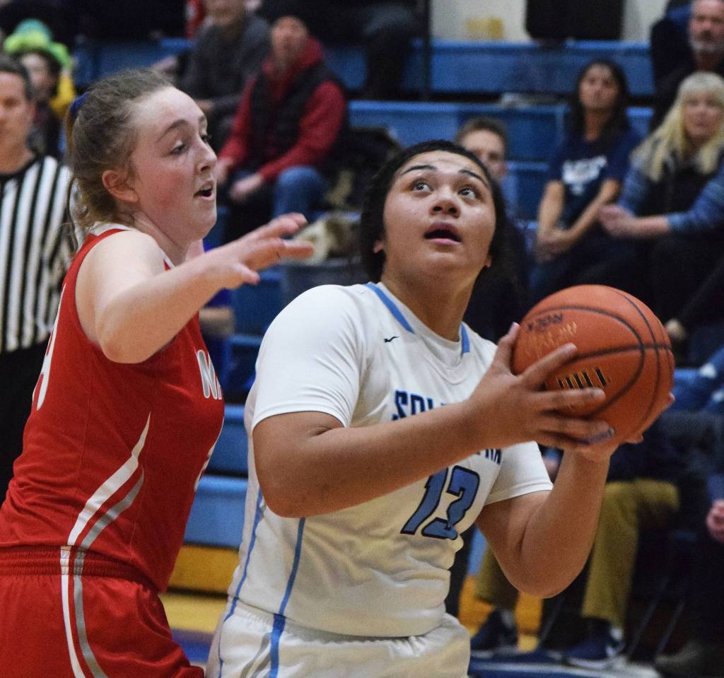 Soldotnas Ituau Tuisaula (13) looks at the rim against Wasillas Bella Hays Friday night in a conference meeting at Soldotna High School. (Photo by Joey Klecka/Peninsula Clarion)