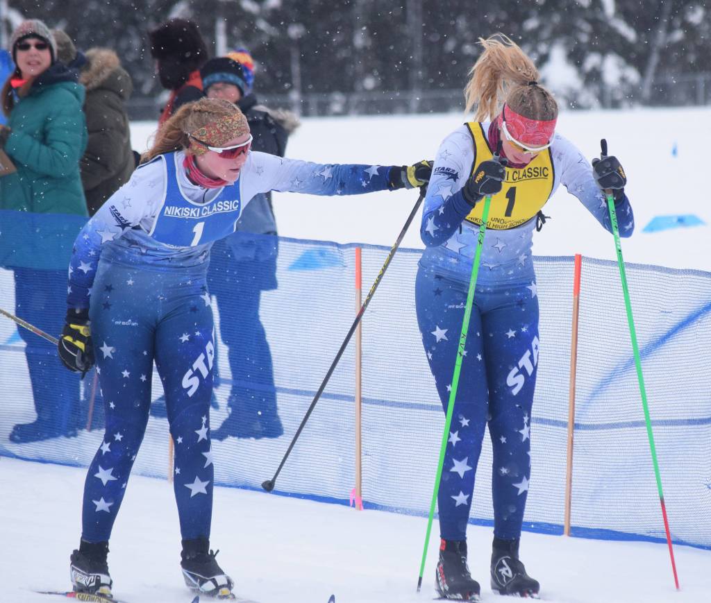 Soldotnas Sonora Martin (left) tags off to teammate Cameron Blackwell in a relay race Saturday afternoon at the Kenai Peninsula Borough nordic ski meet at the Tsalteshi Trails in Soldotna. (Photo by Joey Klecka/Peninsula Clarion)