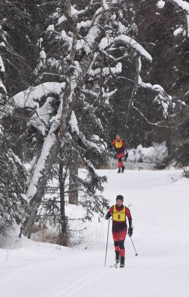 Kenais Jaala Lopez (left) leads teammate Abby Moffett during the second leg of Saturdays girls relay at the Kenai Peninsula Borough nordic ski meet at the Tsalteshi Trails in Soldotna. (Photo by Joey Klecka/Peninsula Clarion)