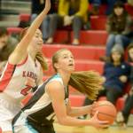 Nikiskis Kaitlyn Johnson powers to the basket against Kenai Centrals Jaycie Calvert on Tuesday, Feb. 19, 2019, at Kenai Central High School. (Photo by Jeff Helminiak/Peninsula Clarion)