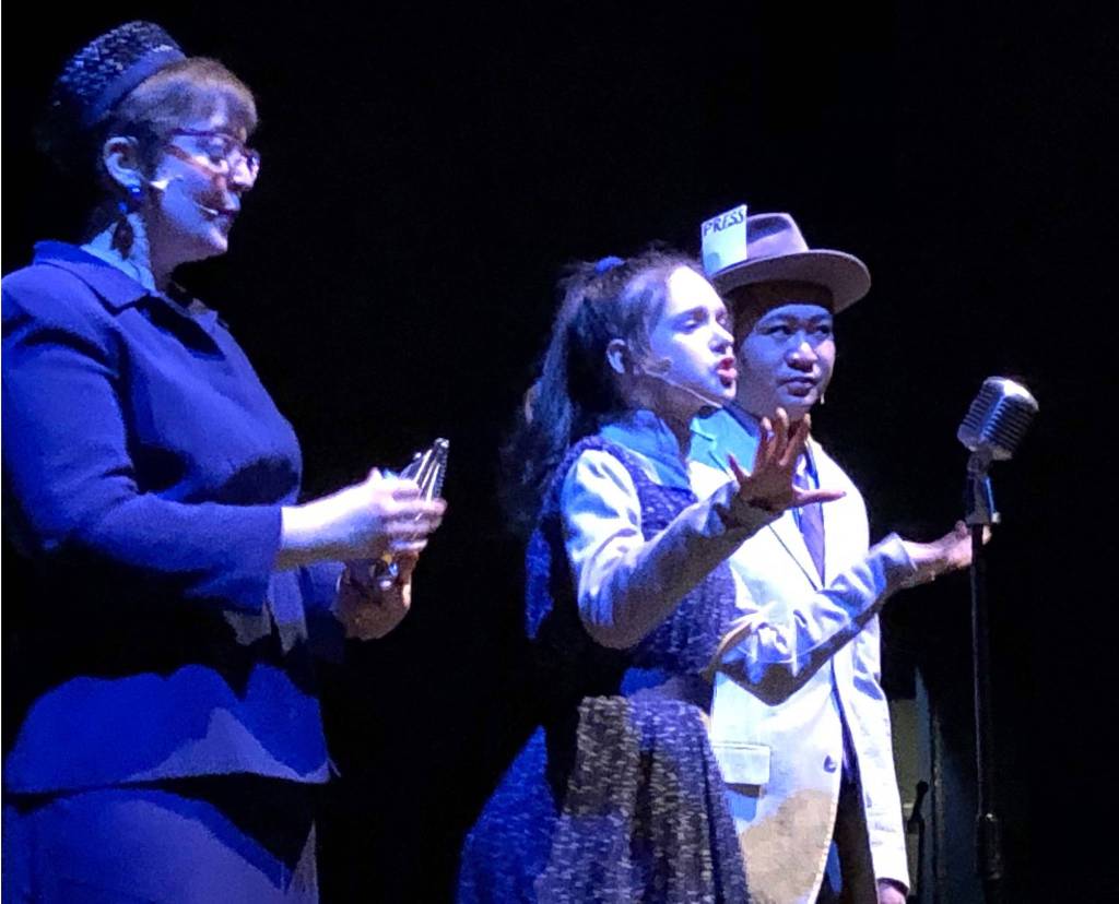 Sara Hondel (left), Kylie Cramer and Spring Sibayan take part in rehearsal Tuesday at the Renee Henderson Auditorium at Kenai Central High School. (Photo by Joey Klecka/Peninsula Clarion)