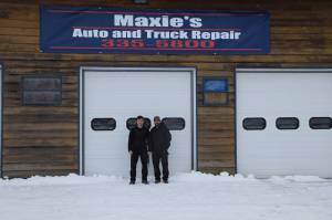 Kris Maxie, right, and his son Cameron, left, stand outside their auto repair shop in Kenai, Alaska on Feb. 20, 2019. (Photo by Brian Mazurek/Peninsula Clarion)