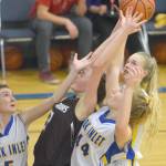 Cook Inlet Academys Jamie Hyatt, Adara Warren and Anna Henderson battle Nikolaevsks Elizabeth Fefelov for the rebound Friday, Dec. 14, 2018, at Cook Inlet Academy in Soldotna. (Photo by Jeff Helminiak/Peninsula Clarion)