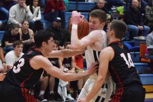 Soldotnas Ray Chumley (middle) becomes sandwiched between Kenais Adam Trujillo (left) and Logan Baker Tuesday in a nonconference contest at Soldotna High School. (Photo by Joey Klecka/Peninsula Clarion)