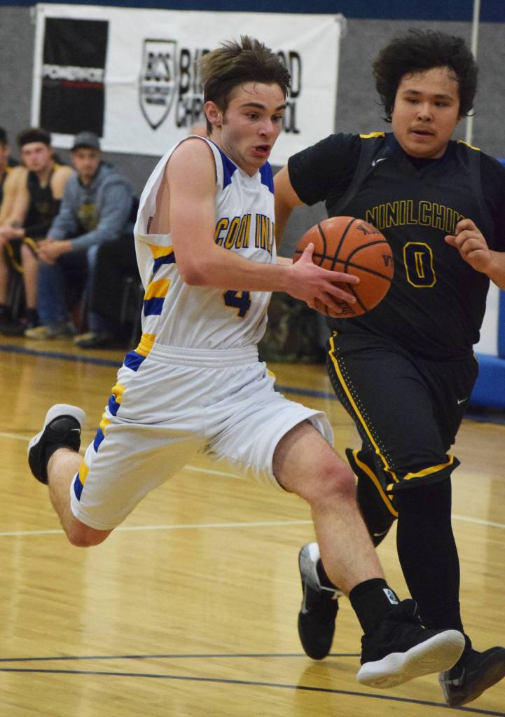Cook Inlet Academys Hunter Moos drives to the rim against Ninilchiks George Nelson (right) Wednesday at the 2019 Peninsula Conference championship tournament at Cook Inlet Academy in Soldotna. (Photo by Joey Klecka/Peninsula Clarion)