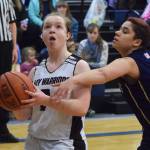 Nikolaevsks Sophia Klaich (left) drives by Ninilchik defender Jade Robuck Saturday in the Peninsula Conference girls second-place contest. (Photo by Joey Klecka/Peninsula Clarion)