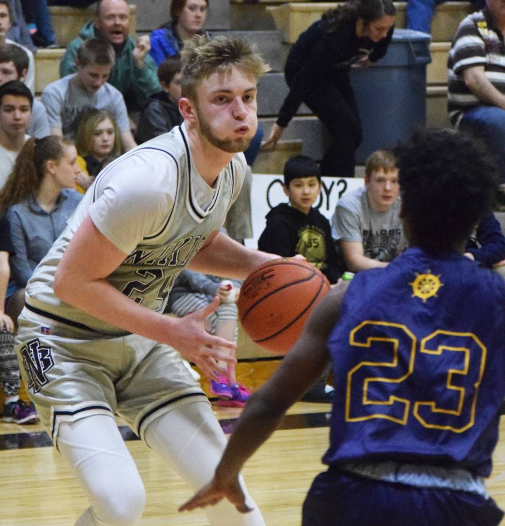 Nikiskis Cody Handley finds space against Homers Eyoab Knapp (23) Friday night in a Southcentral Conference clash at Nikiski High School. (Photo by Joey Klecka/Peninsula Clarion)
