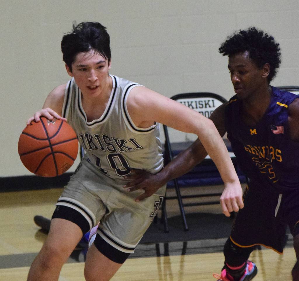 Nikiskis Michael Mysing (left) races past Homers Eyoab Knapp Friday night in a Southcentral Conference clash at Nikiski High School. (Photo by Joey Klecka/Peninsula Clarion)