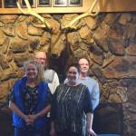 Kenai Elks Lodge members (from left to right) Mary Jackson, Ken Cole, Trina Sanford and Ryan Huss-Green stand in front of the lodges signature mounted elk on Tuesday. (Photo by Brian Mazurek/Peninsula Clarion)