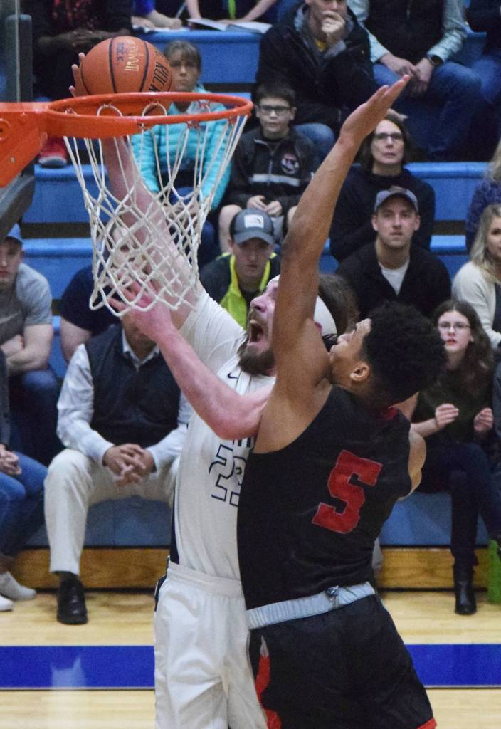 Wasillas Daniel Headdings (5) puts a block on Soldotnas David Michael Friday night in the Northern Lights Conference semifinals at Soldotna High School. (Photo by Joey Klecka/Peninsula Clarion)