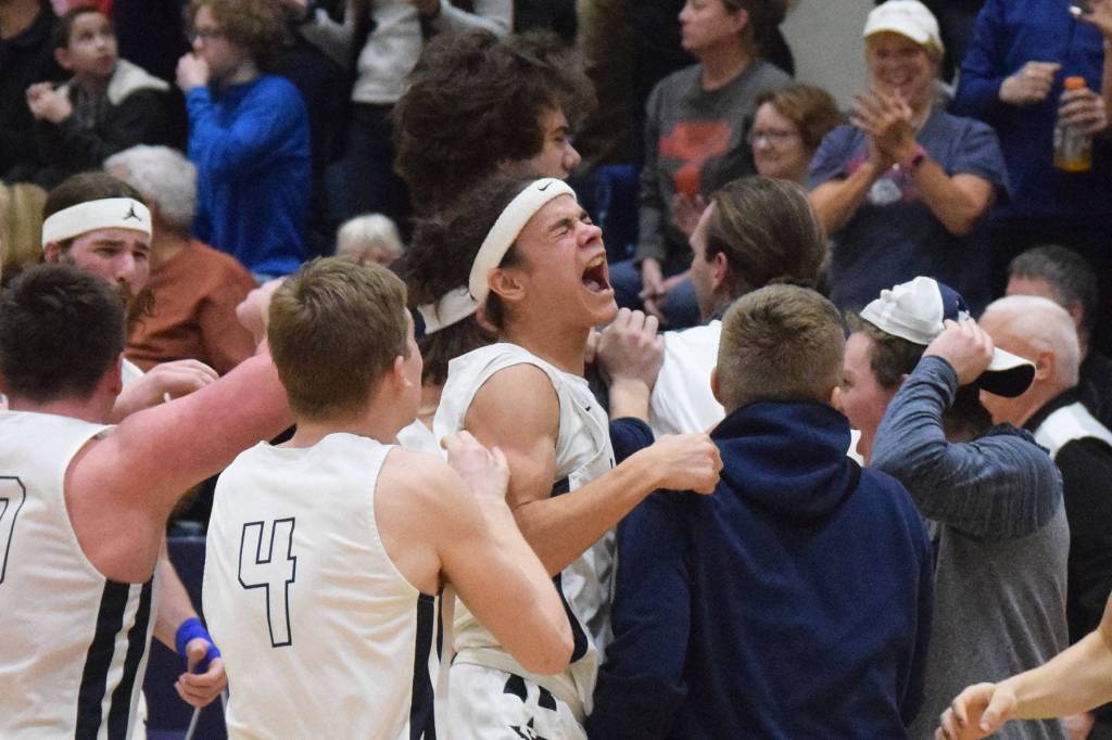 Soldotnas Mekhai Rich (middle) celebrates with teammates Friday night after a win over Wasilla in the Northern Lights Conference semifinals at Soldotna High School. (Photo by Joey Klecka/Peninsula Clarion)