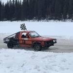 Owner/driver JT Hawkins in his #13 car sporting the checkered flag. (Photo provided by Kenai Peninsula Ice Race Association)