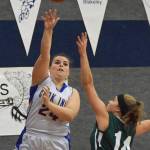 Cook Inlet Academys Anna Cizek (24) takes a shot in front of Birchwood Christian defender Kailyn Kaas Feb. 27, 2019, at the 2019 Peninsula Conference championship tournament at Cook Inlet Academy in Soldotna. (Photo by Joey Klecka/Peninsula Clarion)