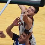 Nikolaevsks Michael Trail (top) leaps up for a rebound above Sand Points Steven Galovin Wednesday at the Class 1A boys state basketball championships at the Alaska Airlines Center in Anchorage. (Photo by Joey Klecka/Peninsula Clarion)