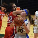 Cook Inlet Academys Sophia Nelson (10) drives past Kake defender Kylie Rose-Wooton for a bucket Wednesday at the Class 1A girls basketball state tournament at the Alaska Airlines Center in Anchorage. (Photo by Joey Klecka/Peninsula Clarion)