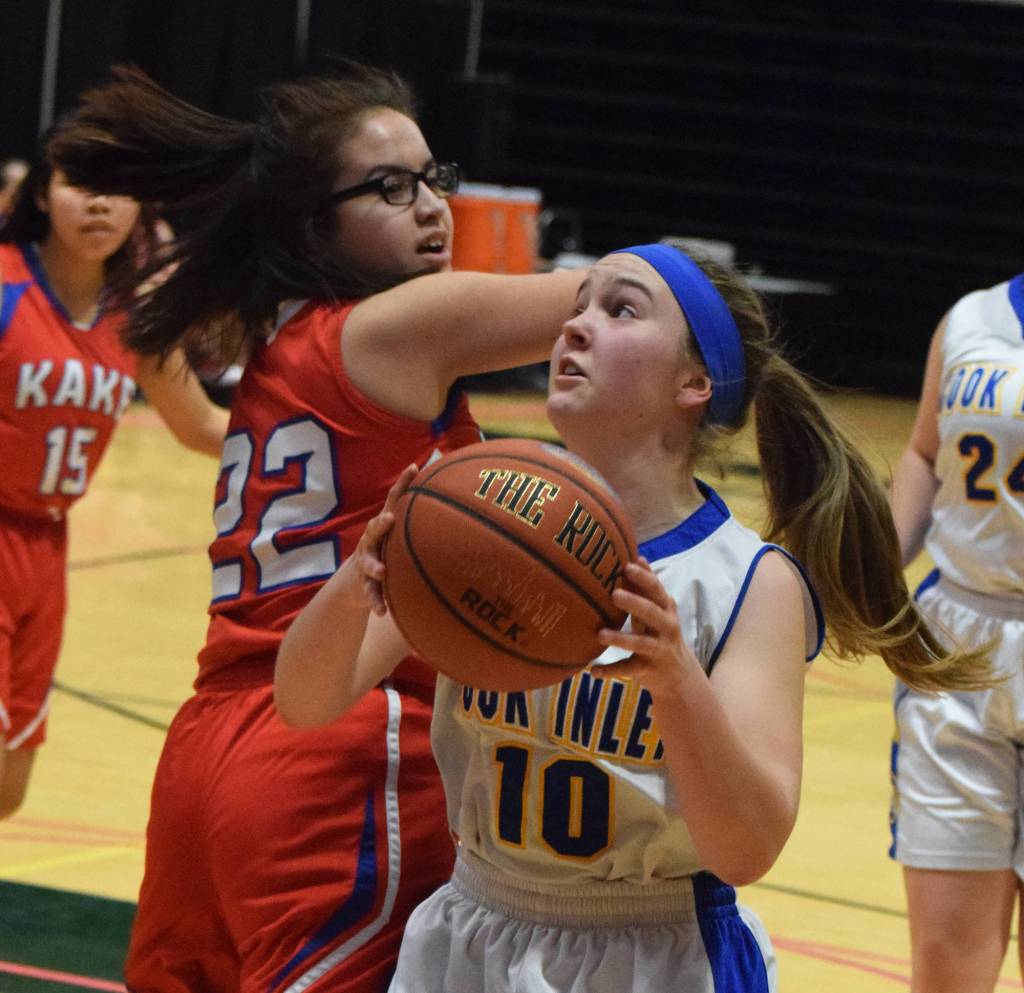 Cook Inlet Academys Sophia Nelson (10) drives past Kake defender Kylie Rose-Wooton for a bucket Wednesday at the Class 1A girls basketball state tournament at the Alaska Airlines Center in Anchorage. (Photo by Joey Klecka/Peninsula Clarion)