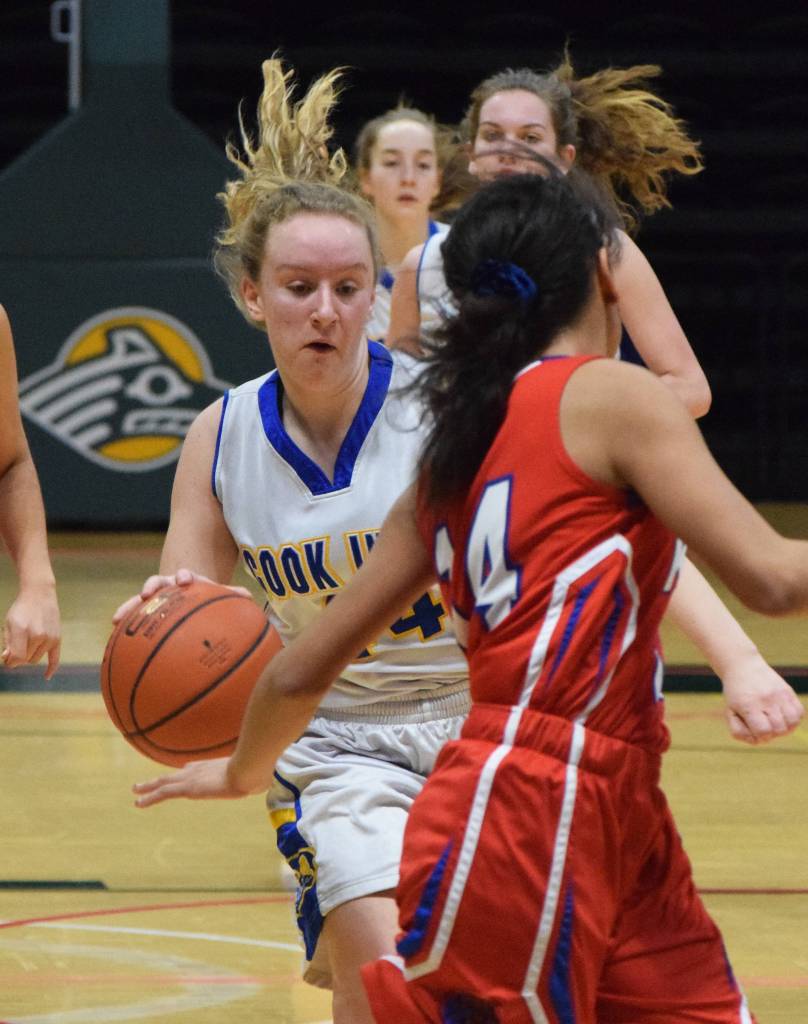 Cook Inlet Academys Adara Warren (left) races down the court Wednesday in a first-round contest against Kake at the Class 1A girls basketball state tournament at the Alaska Airlines Center in Anchorage. (Photo by Joey Klecka/Peninsula Clarion)