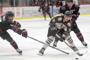 Brown Bears forward Andy Walker carries the puck between Corpus Christis Anthony Firriolo and Kyle Moore on Friday, Feb. 8, 2019, at the Soldotna Regional Sports Complex. (Photo by Jeff Helminiak/Peninsula Clarion)