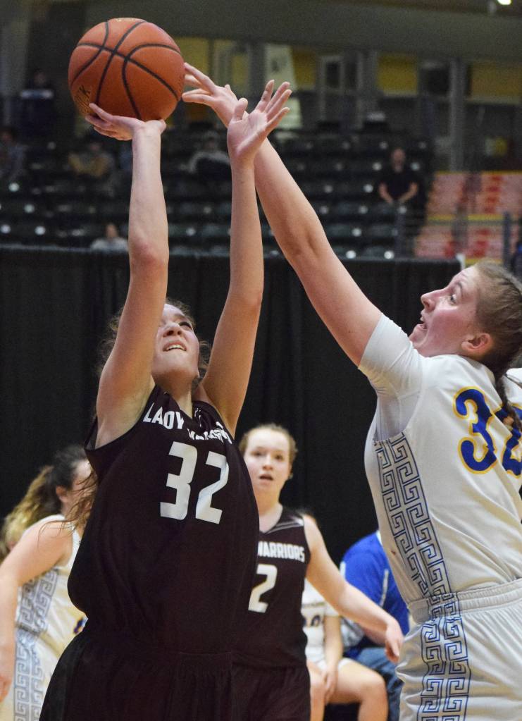 Nikolaevsks Elizabeth Fefelov (left) is rejected by Tri-Valleys Rachel Cockman Thursday at the Class 1A girls state basketball tournament in Anchorage. (Photo by Joey Klecka/Peninsula Clarion)