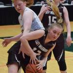 Nikolaevsks Kerianna Lasiter (below) beats Tri-Valleys Victoria Pennington to a rebound Thursday at the Class 1A girls state basketball tournament in Anchorage. (Photo by Joey Klecka/Peninsula Clarion)