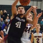 Nikolaevsks Michael Trail (41) grabs a rebound ahead of Lumen Christis Timothy Bennett Thursday at the Class 1A boys state basketball tournament in Anchorage. (Photo by Joey Klecka/Peninsula Clarion)