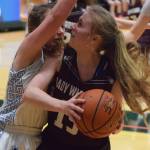 Nikolaevsks Markiana Yakunin (right) drives to the rim against Tri-Valleys Jazmyn Byfluglien Thursday at the Class 1A girls state basketball tournament in Anchorage. (Photo by Joey Klecka/Peninsula Clarion)