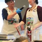 Carri Thurman, left, and Sharon Roufa, right, present a cooking demo on baking with sourdough Saturday, March 9, 2019 at the Alaska Food Festival at Lands End Resort in Homer, Alaska. (Photo by Megan Pacer/Homer News)