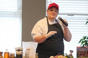 Mandy Dixon, owner of La Baleine, speaks during a cooking demo during the Alaska Food Festival on Saturday, March 9, 2019 at Lands End Resort in Homer, Alaska. She and her mother, Kirseten, who owns Tutka Bay Lodge, spoke about their travels to other countries and how that inspires their cooking in Alaska. (Photo by Megan Pacer/Homer News)