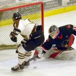 Minnesota Magicians goalie Jack Robbel makes a save on Kenai River Brown Bears forward Alex Klekotka on Thursday, March 14, 2019, at the Soldotna Regional Sports Complex. (Photo by Jeff Helminiak/Peninsula Clarion)