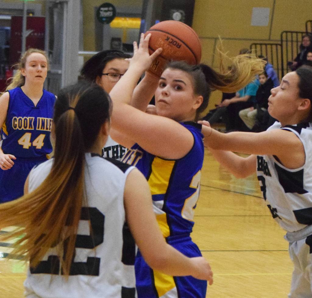 Cook Inlet Academys Anna Cizek looks for an open teammate Friday against Shishmaref at the Class 1A state tournament at the Alaska Airlines Center in Anchorage. (Photo by Joey Klecka/Peninsula Clarion)