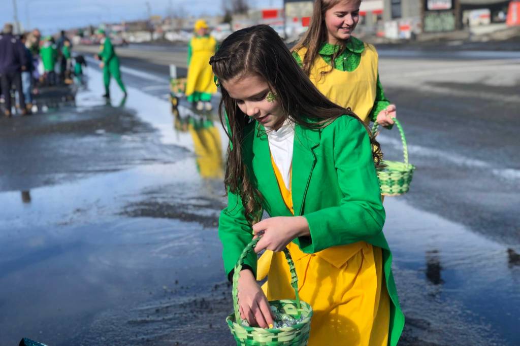 A parade participant passes out candy at Soldotnas St. Patricks Day Parade on Sunday, March 17, 2019, in Soldotna, Alaska. (Photo by Victoria Petersen/Peninsula Clarion)