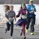 Willow Graham, Courtney Galloway and Maria Sweppy run the Shamrock Shuffle on Sunday, March 17, 2019, at the Soldotna Regional Sports Complex. (Photo by Jeff Helminiak/Peninsula Clarion)