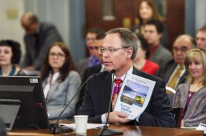Commissioner Designee Bruce Tangeman presents the states revenue forecast to the Senate Finance Committee at the Capitol on Wednesday, Jan. 16, 2019. (Michael Penn | Juneau Empire)