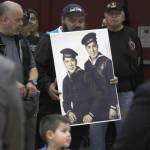 Family members of Mark and Harvey Jacobs hold a picture of the brothers during a ceremony honoring Tlingit code talkers on Monday, March 18, 2019. (Alex McCarthy | Juneau Empire)