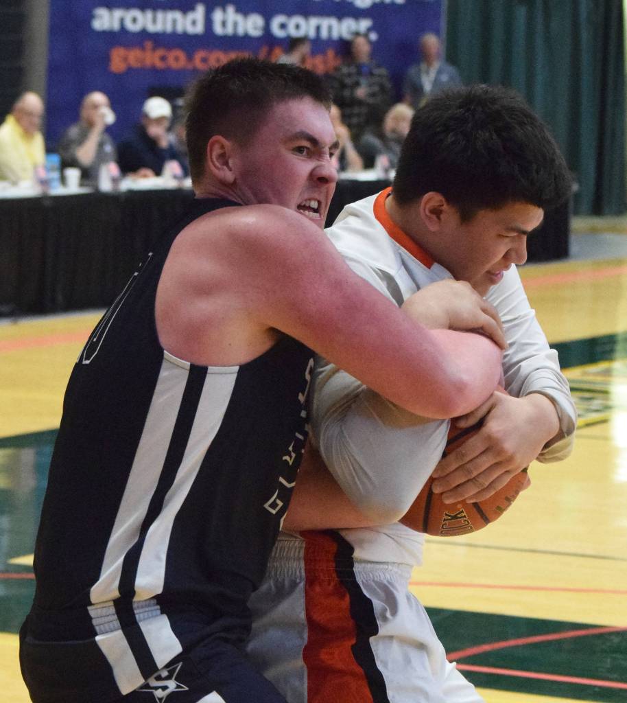 Soldotnas Brock Kant (left) wrestles with Wests Anthony Snow for a rebound Thursday, Mar. 21, 2019, at the Class 4A state championship tournament at the Alaska Airlines Center in Anchorage. (Photo by Joey Klecka/Peninsula Clarion)